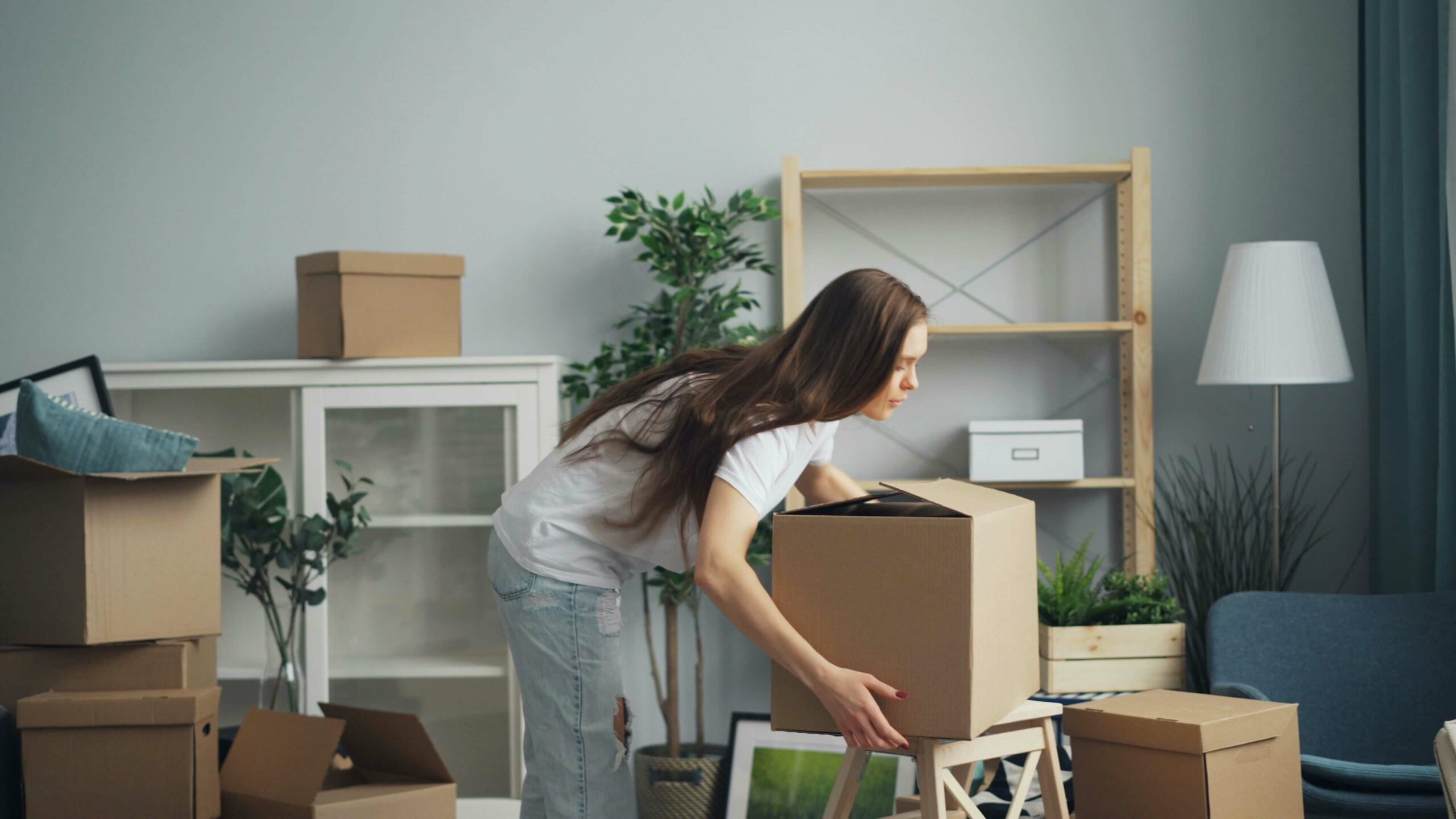 femme portant ses cartons de déménagement